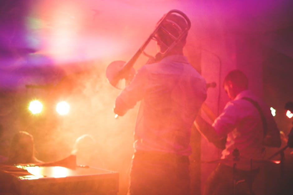 Vibrant live music performance featuring a trombone player on stage in a nightclub setting.
